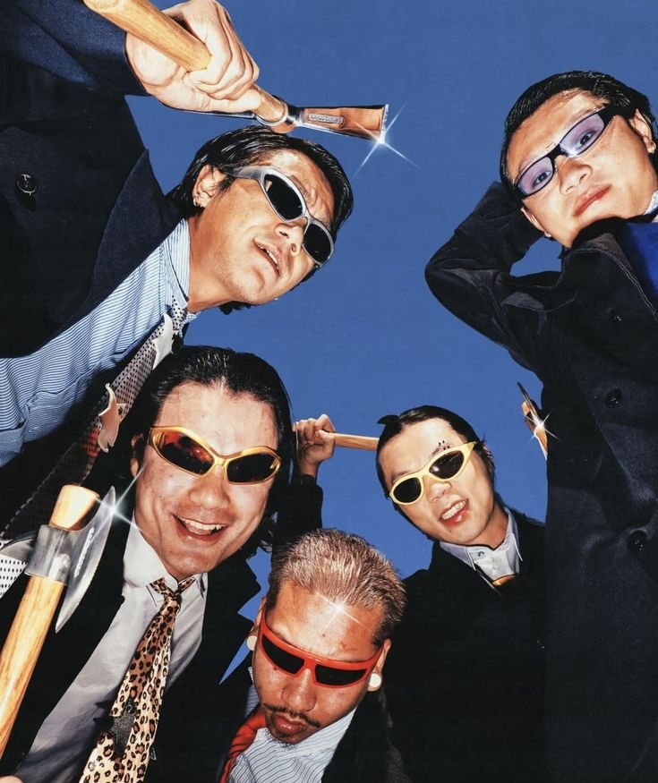 men in suits and sunglasses posing