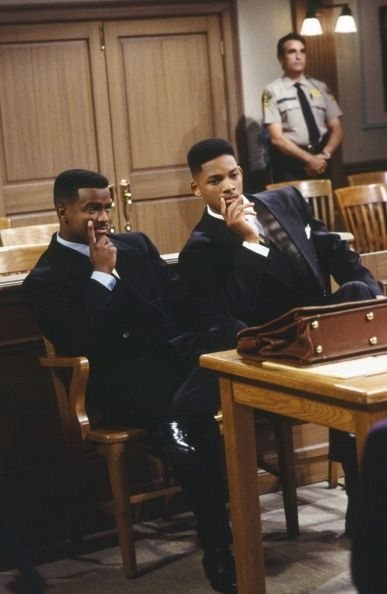two men in suits on their cell phones