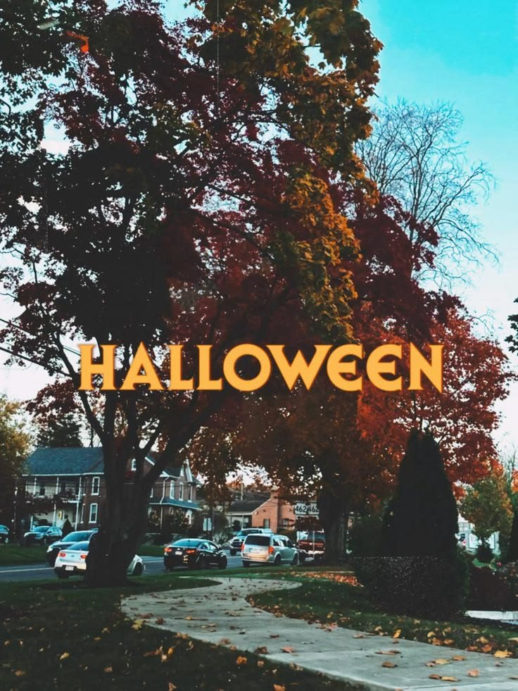 a halloween sign in front of trees