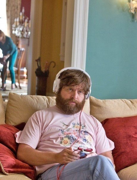 a man with headphones on a couch