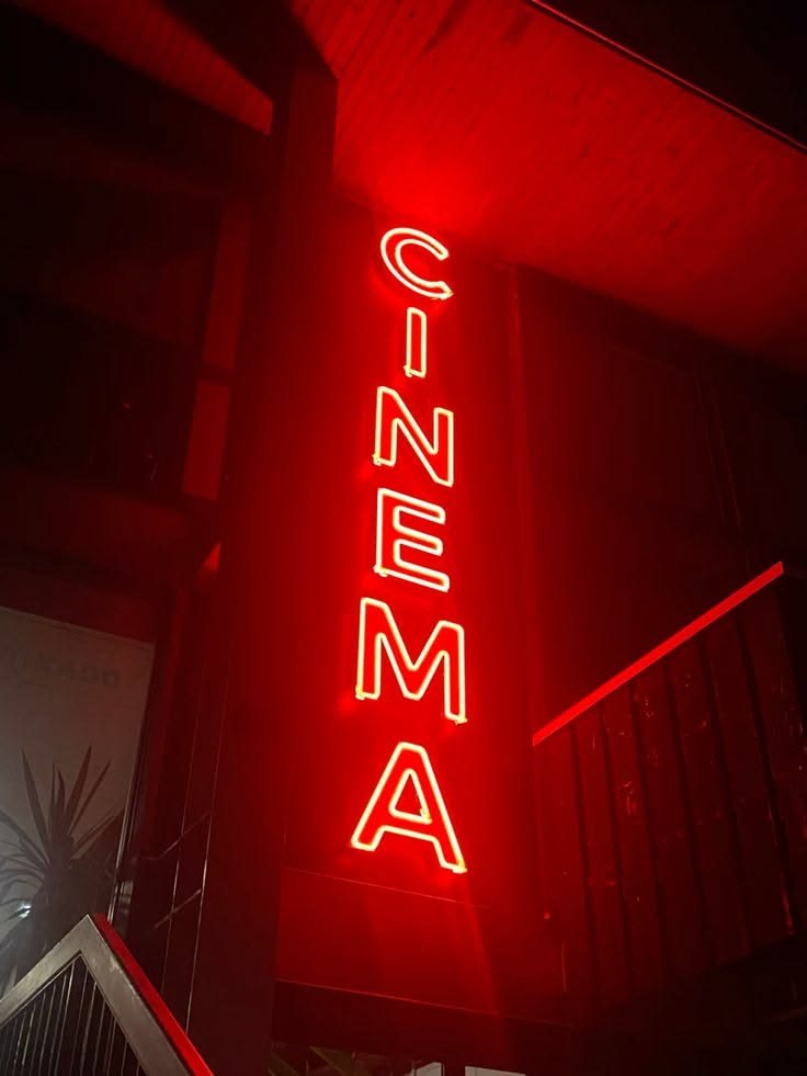 a red neon cinema sign