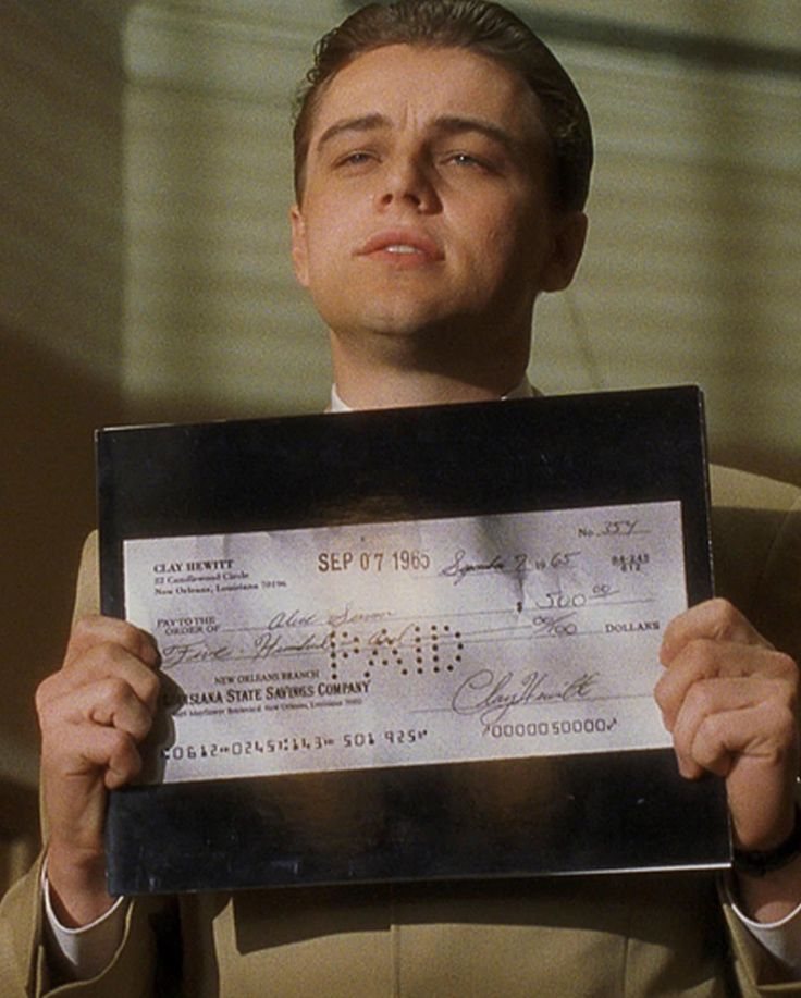a man holding up a large check