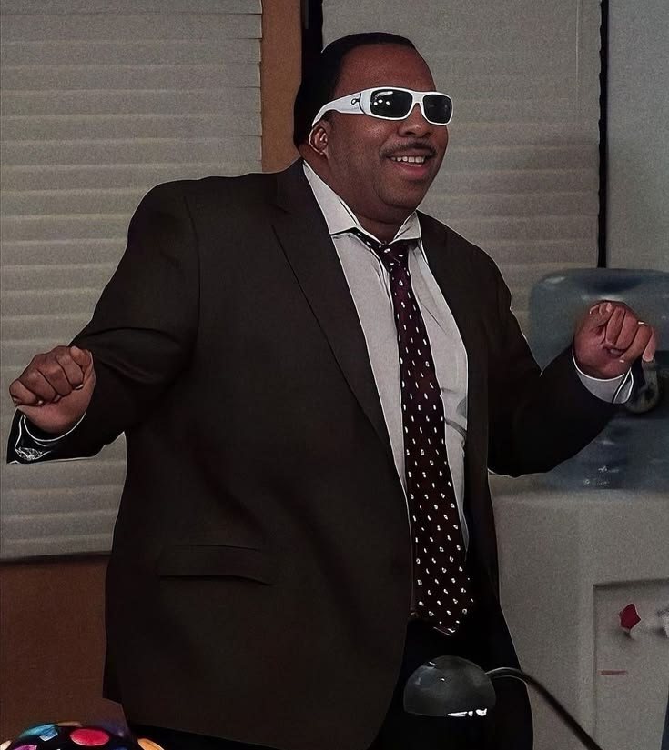 a man in a suit with sunglasses
