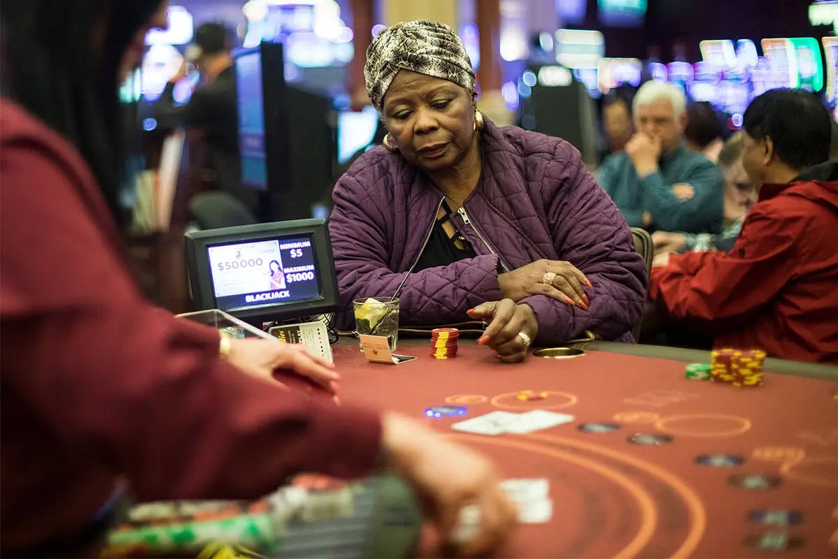 A player staring at her last chips at a Las Vegas blackjack table