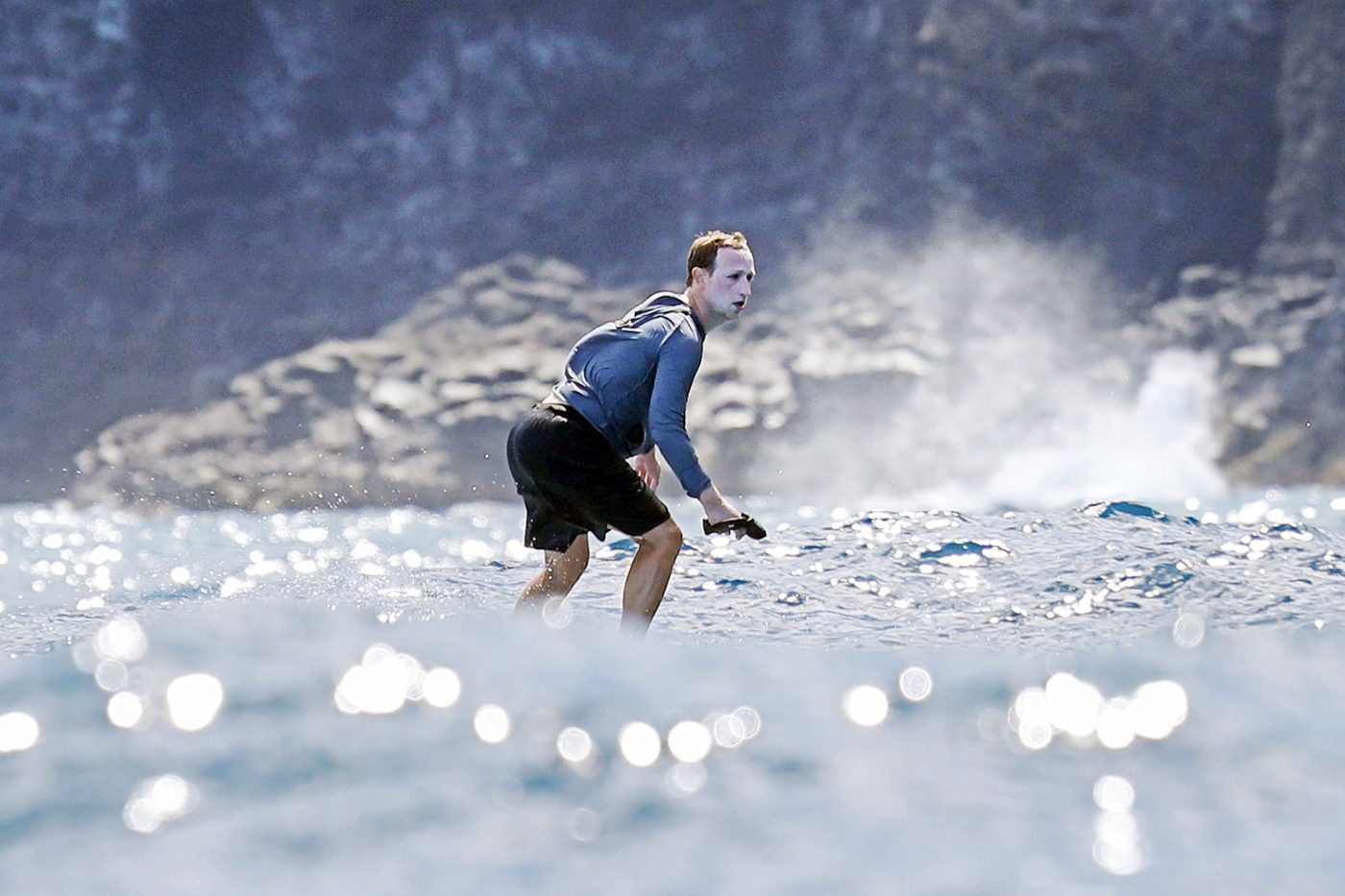 Mark Zuckerberg surfing in Hawaii with his face covered in sunscreen